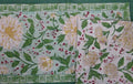 Floral patterned table runner with green border on a white background