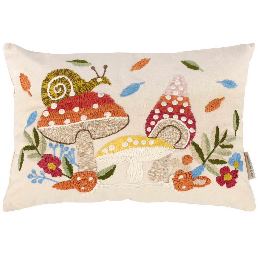 Decorative pillow with embroidered snail and mushroom design on a white background