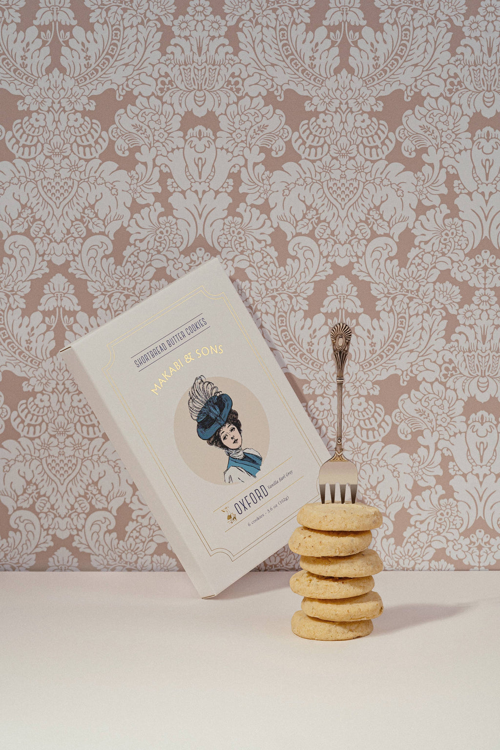 Stack of cookies with a package and patterned wallpaper in the background