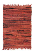 Textured red and black area rug with fringes on a plain background
