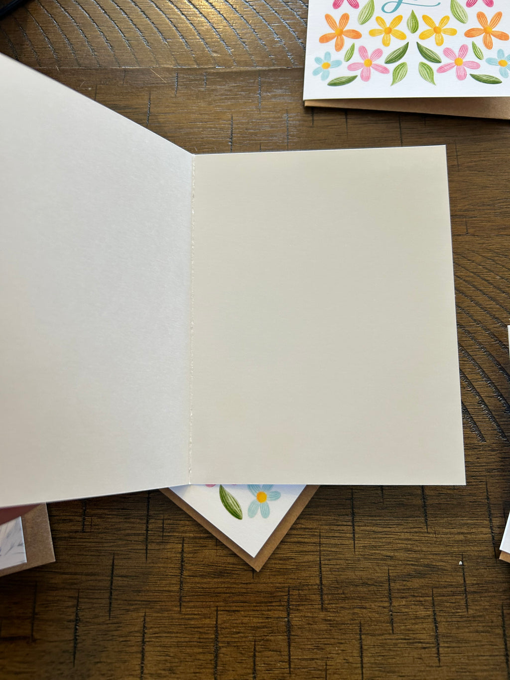 White blank interior of a greeting card on wood background