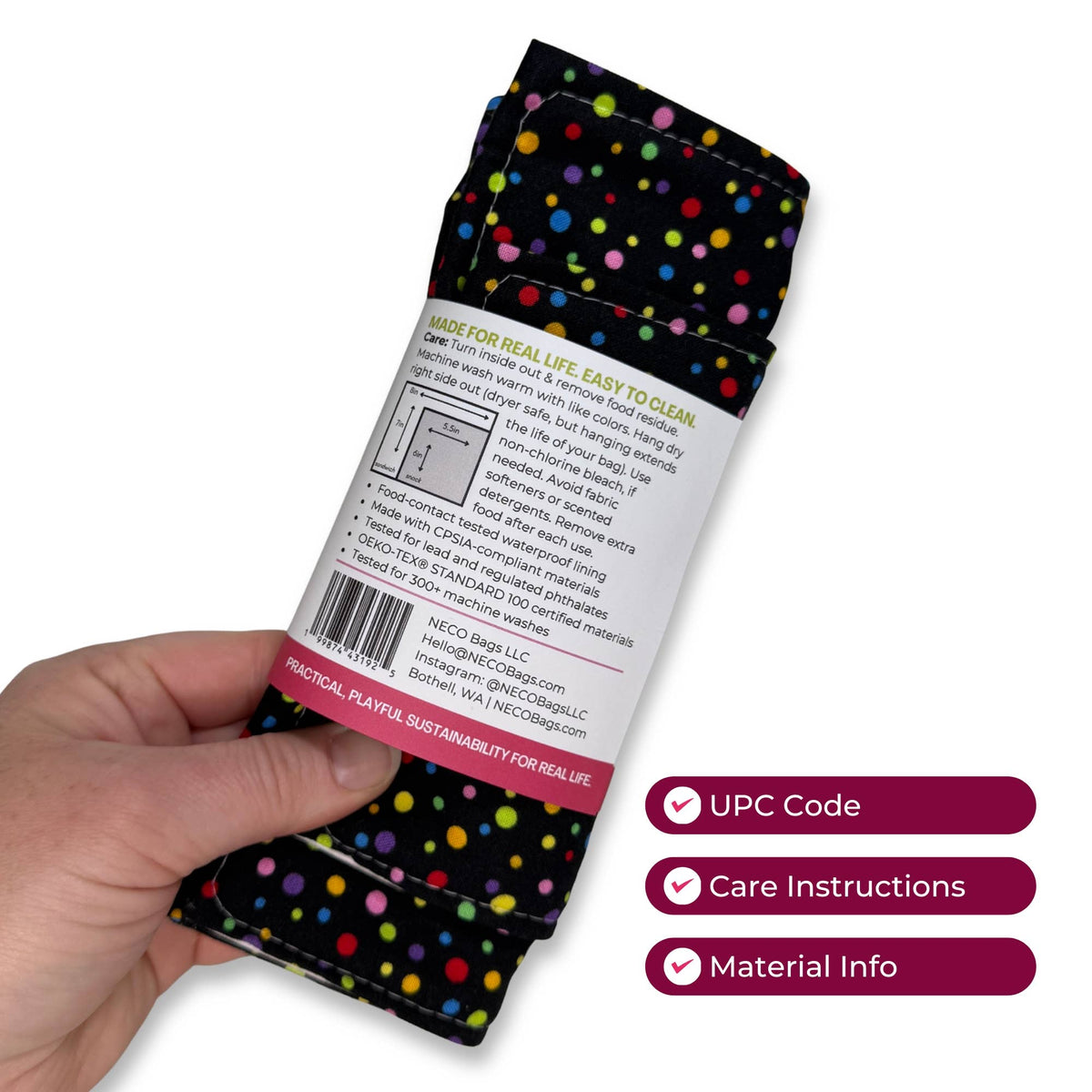 A hand holds a folded black fabric item with multicolored polka dots and a white paper label showing product information. Three dark pink callout badges on the right read 'UPC Code', 'Care Instructions', and 'Material Info'.