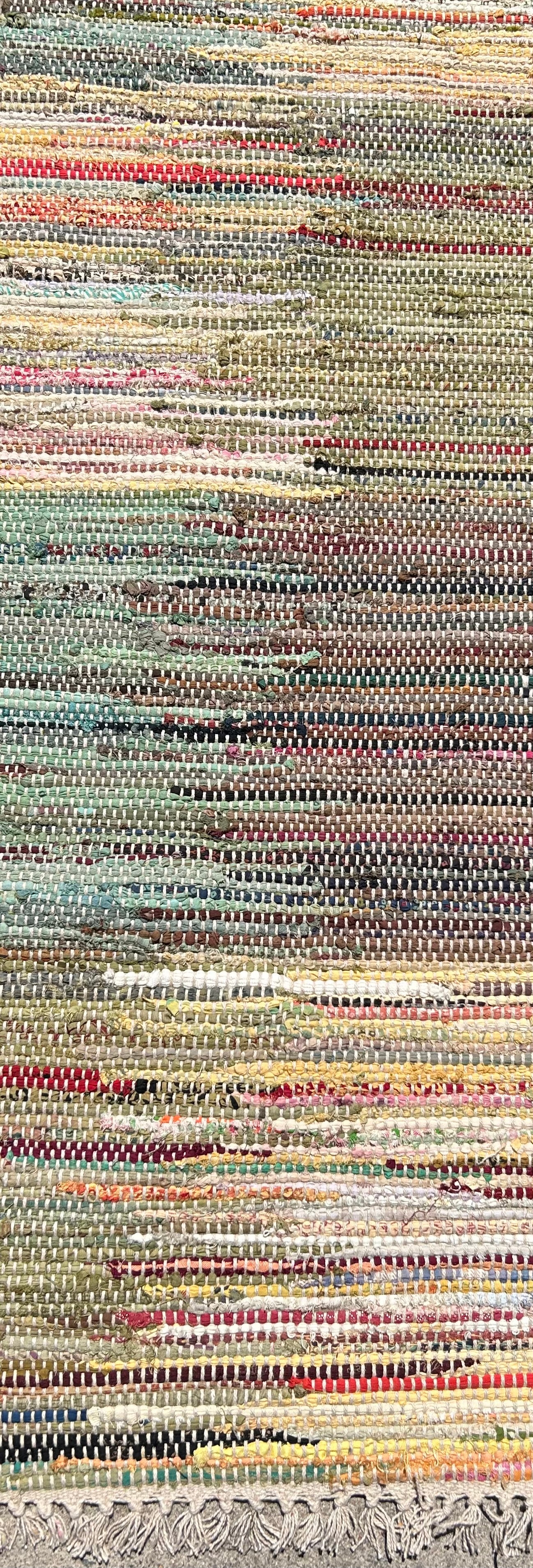 Multicolored woven rug with a striped pattern