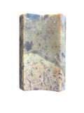 Top View of a soapstone soap dish. Rectangular concave shape neutral multi color.