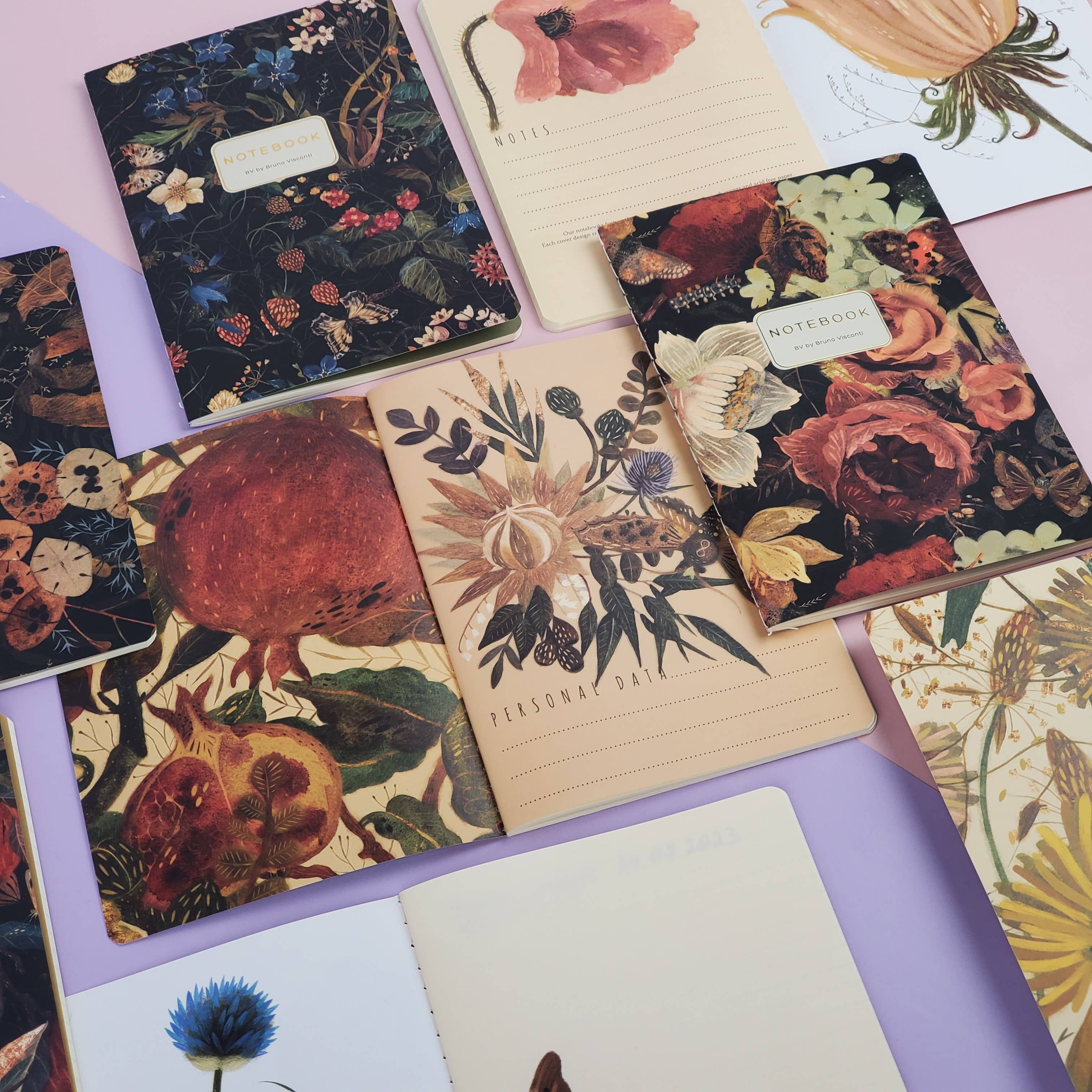 Collection of floral notebooks and planners on a colorful background