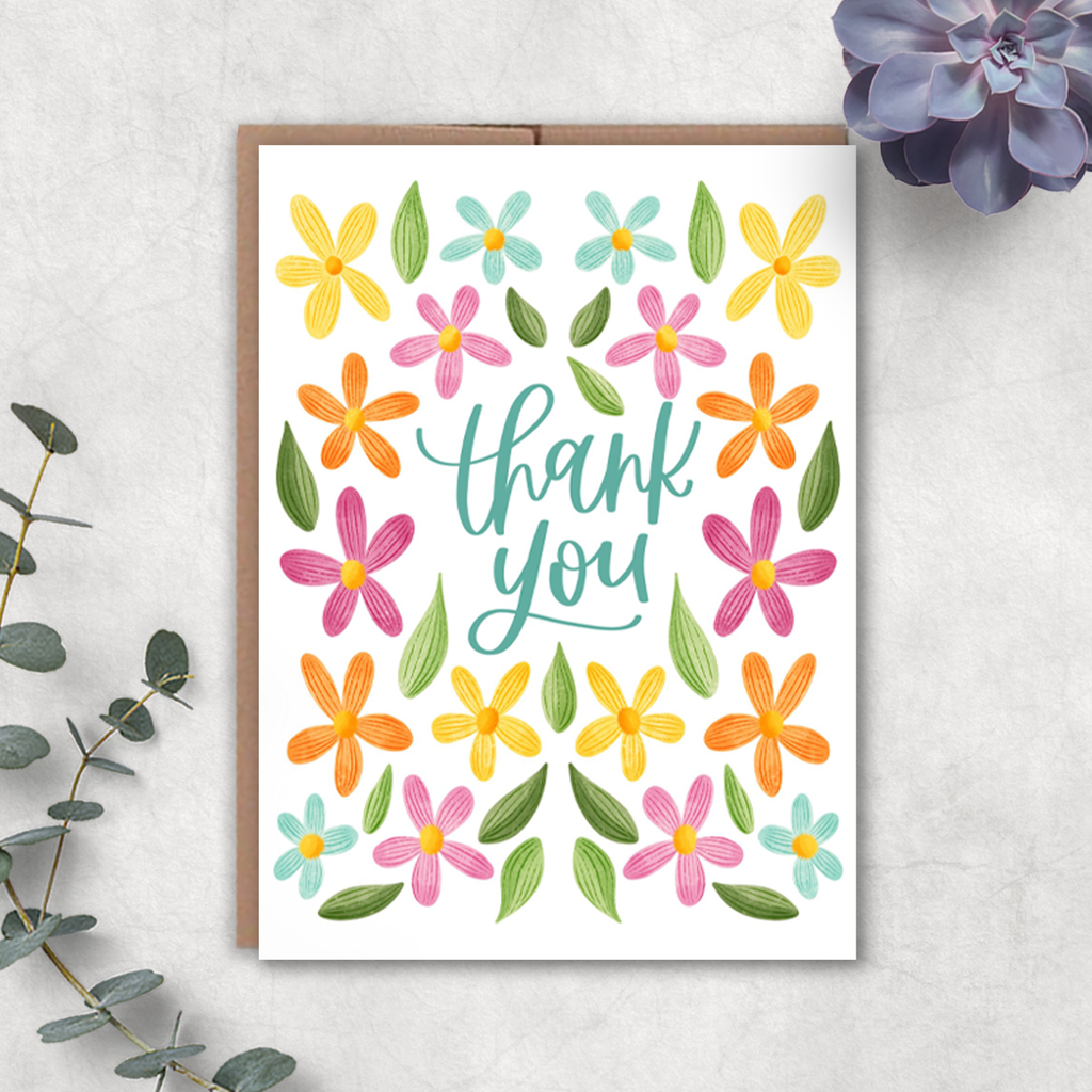 Greeting card with colorful flowers and 'thank you' text on a white background