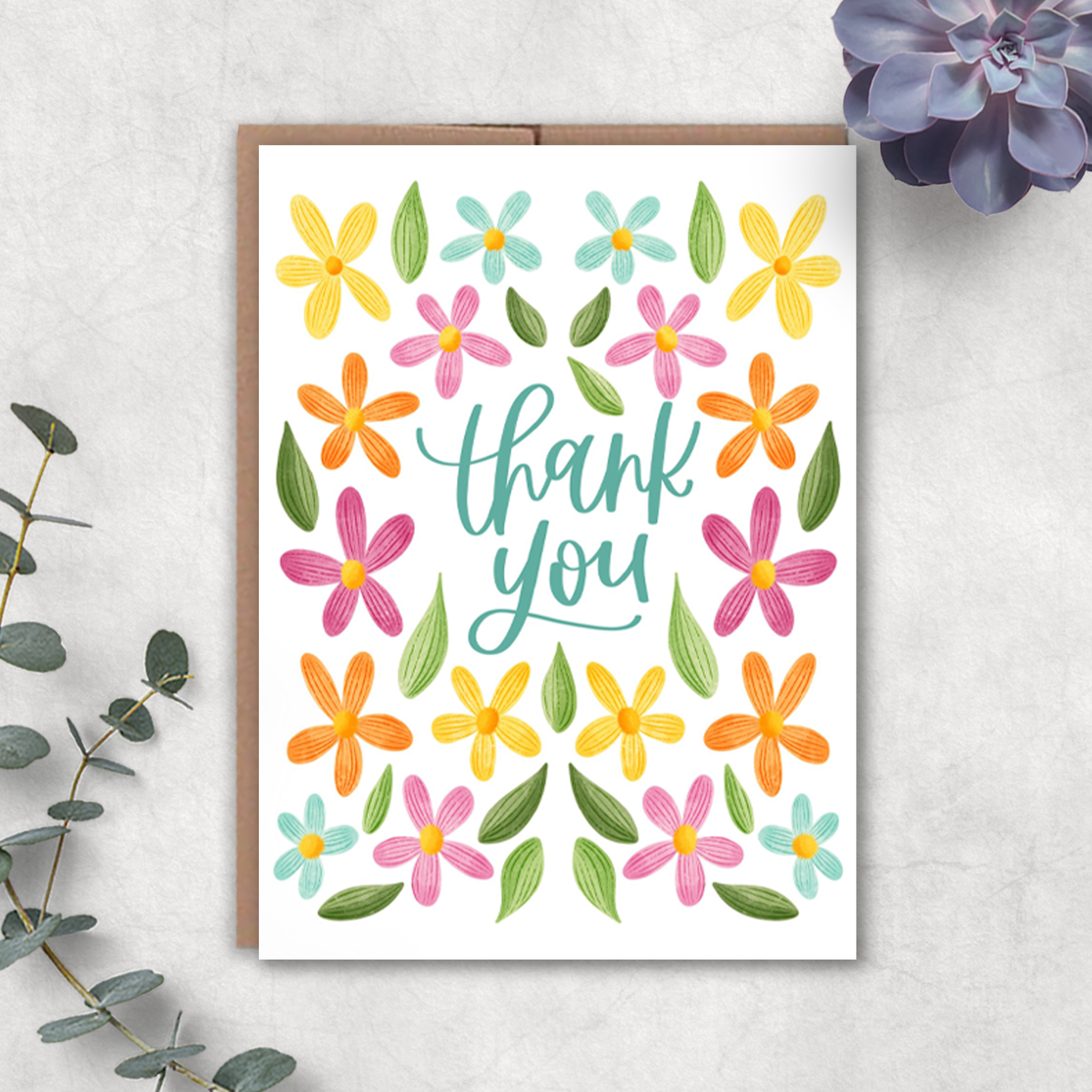 Greeting card with colorful flowers and 'thank you' text on a white background