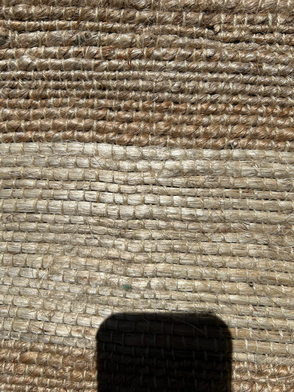 Close-up of textured rug showing stripes 