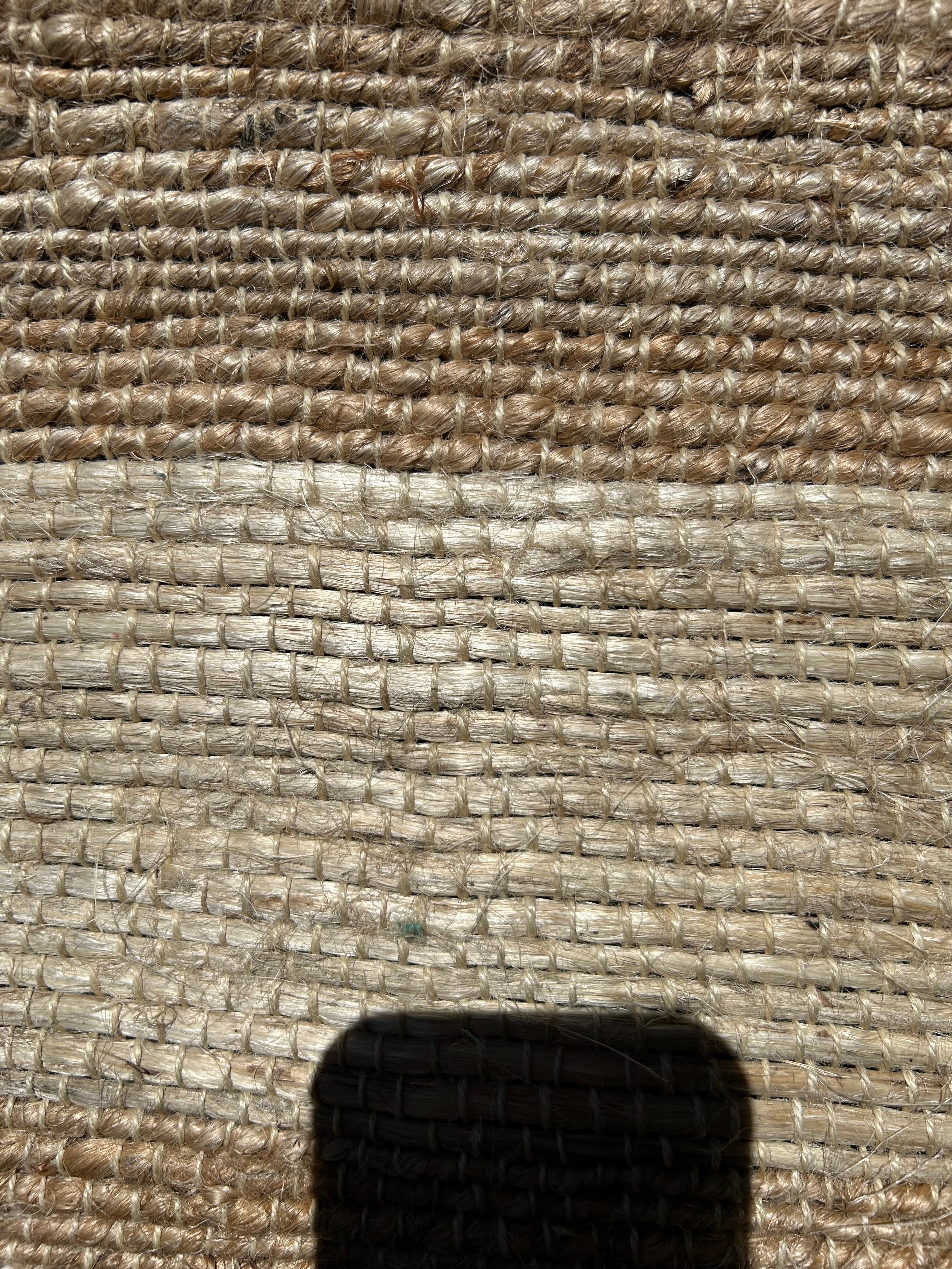 Close-up of textured rug showing stripes 
