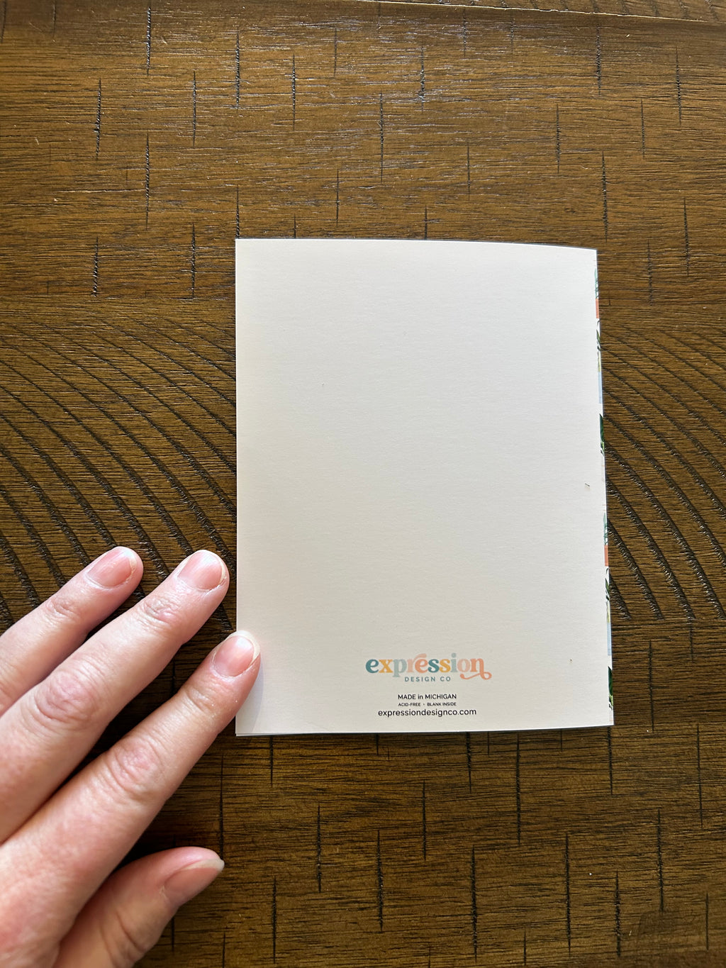 White card with text on a wooden surface