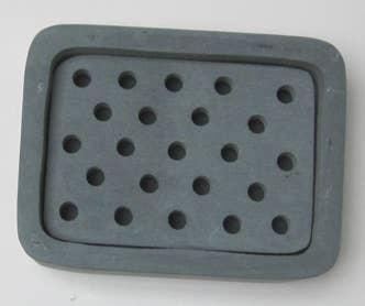 Rectangular soapstone soap dish with holes on a white background