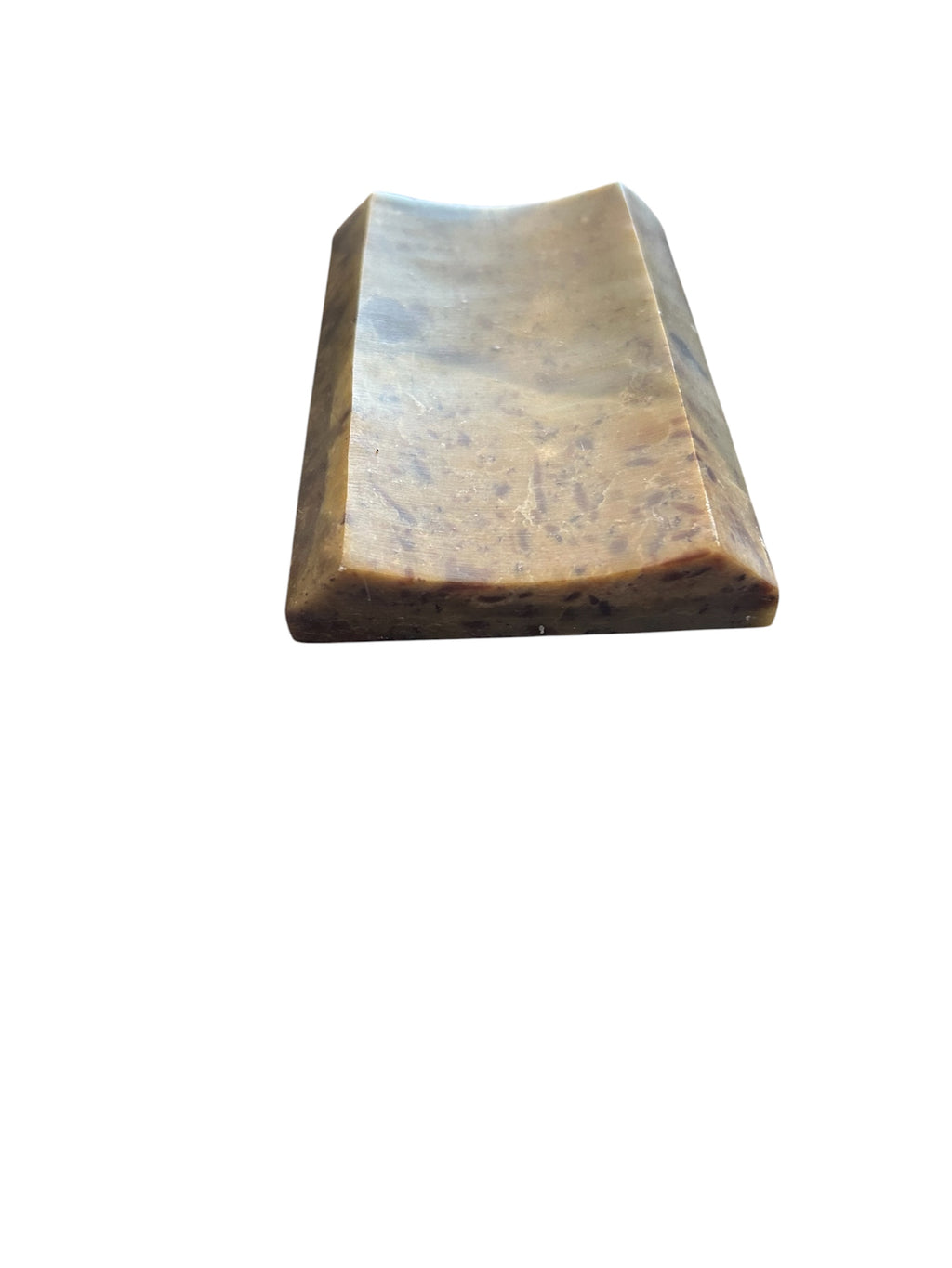 Side View of a soapstone soap dish. Rectangular concave shape neutral multi color.