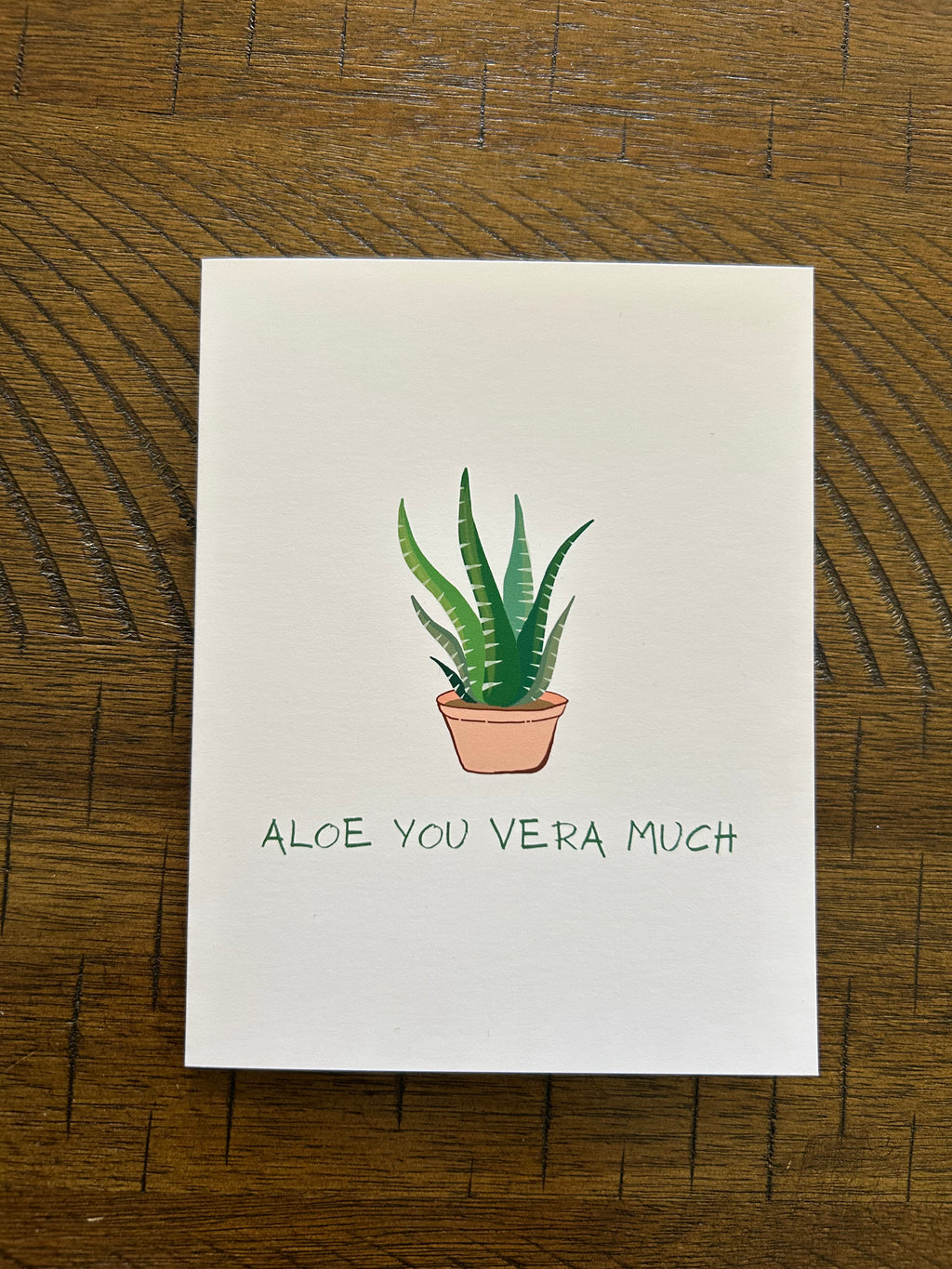 Greeting card with a potted aloe vera plant and text 'Aloe You Vera Much' on a white background.