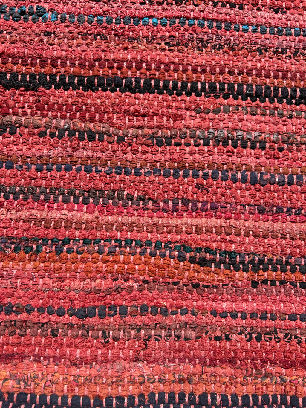 Close-up of a textured red and black rug pattern