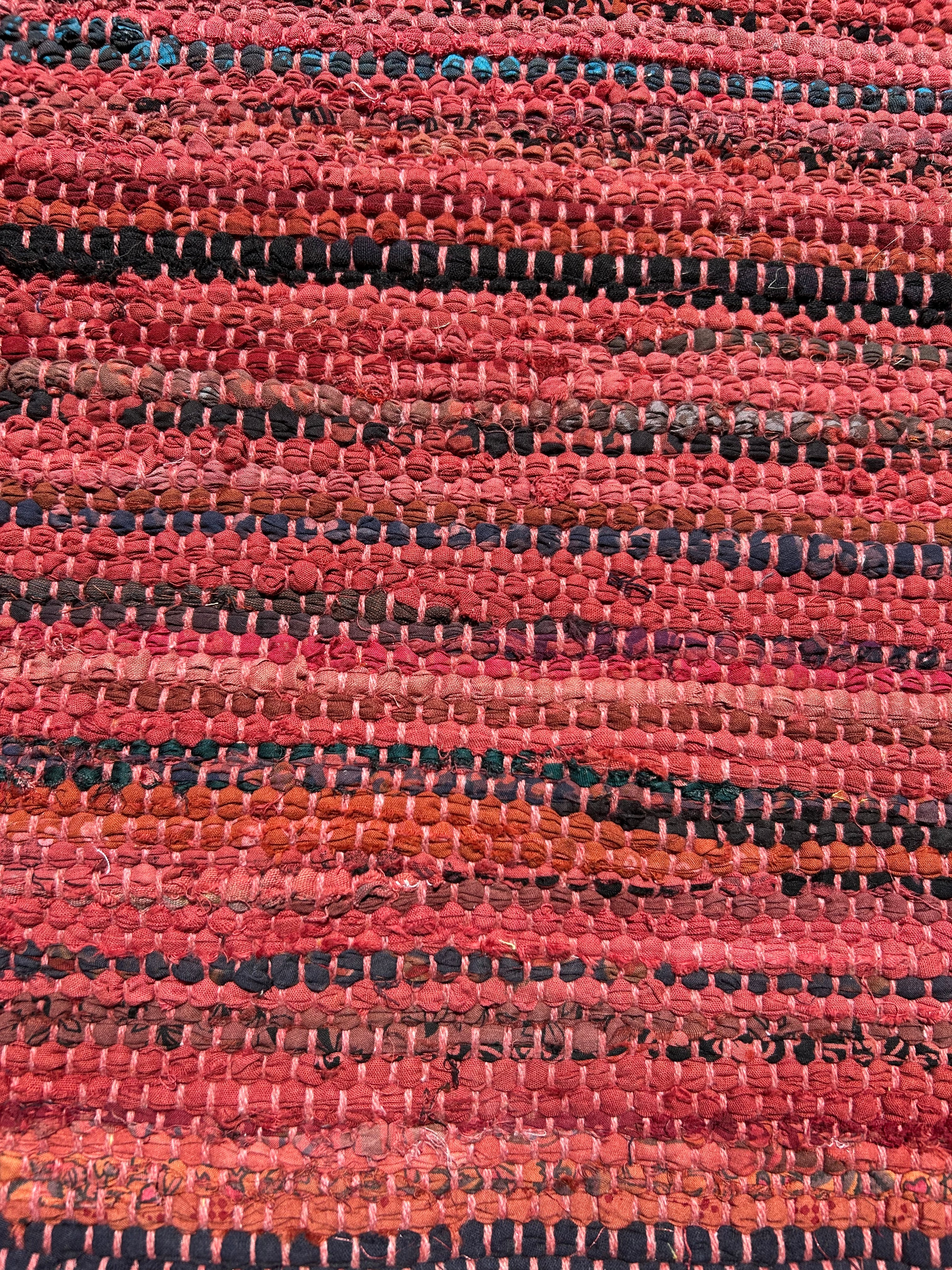 Close-up of a textured red and black rug pattern