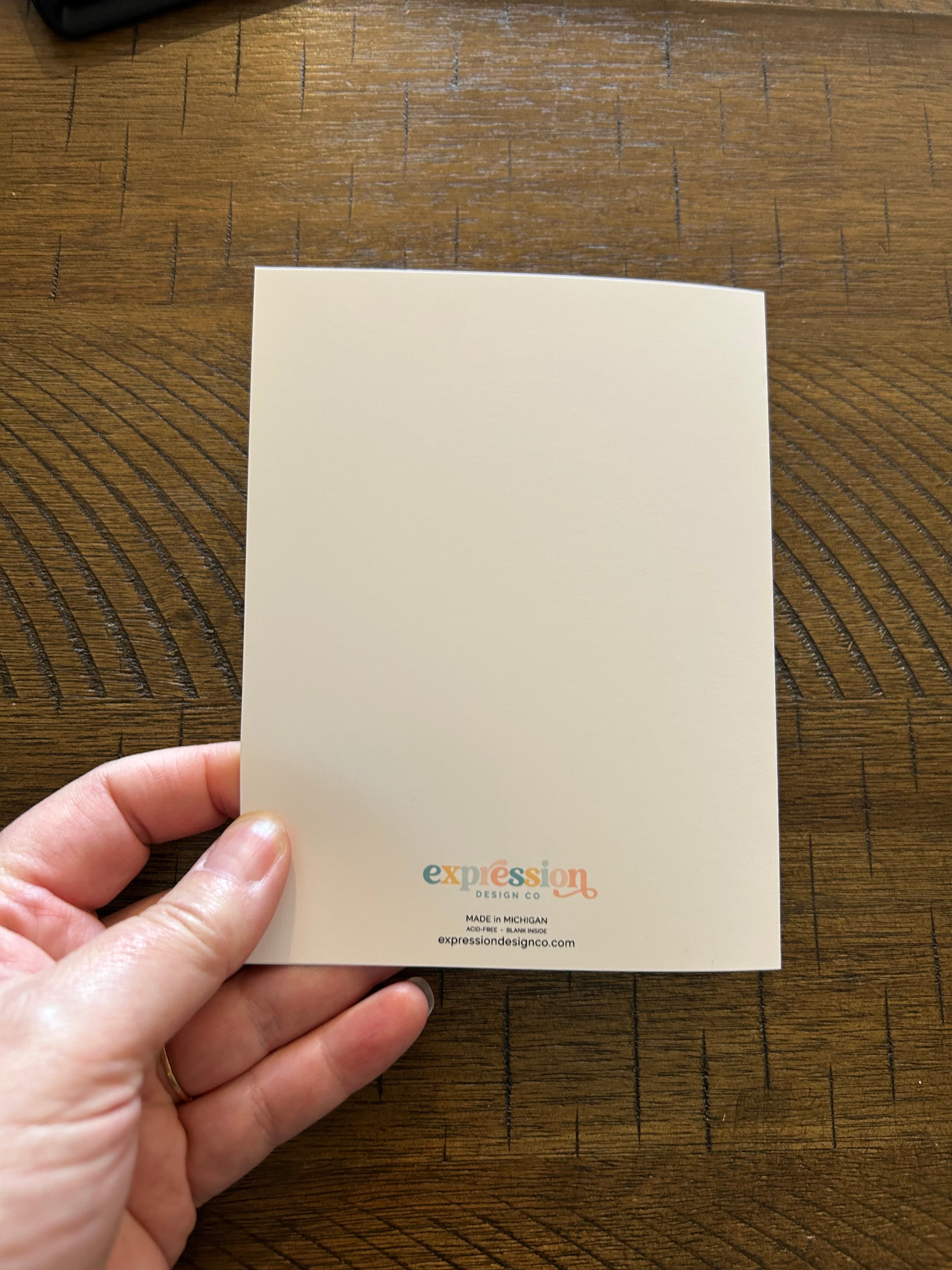 Back of Greeting card on a wood background.