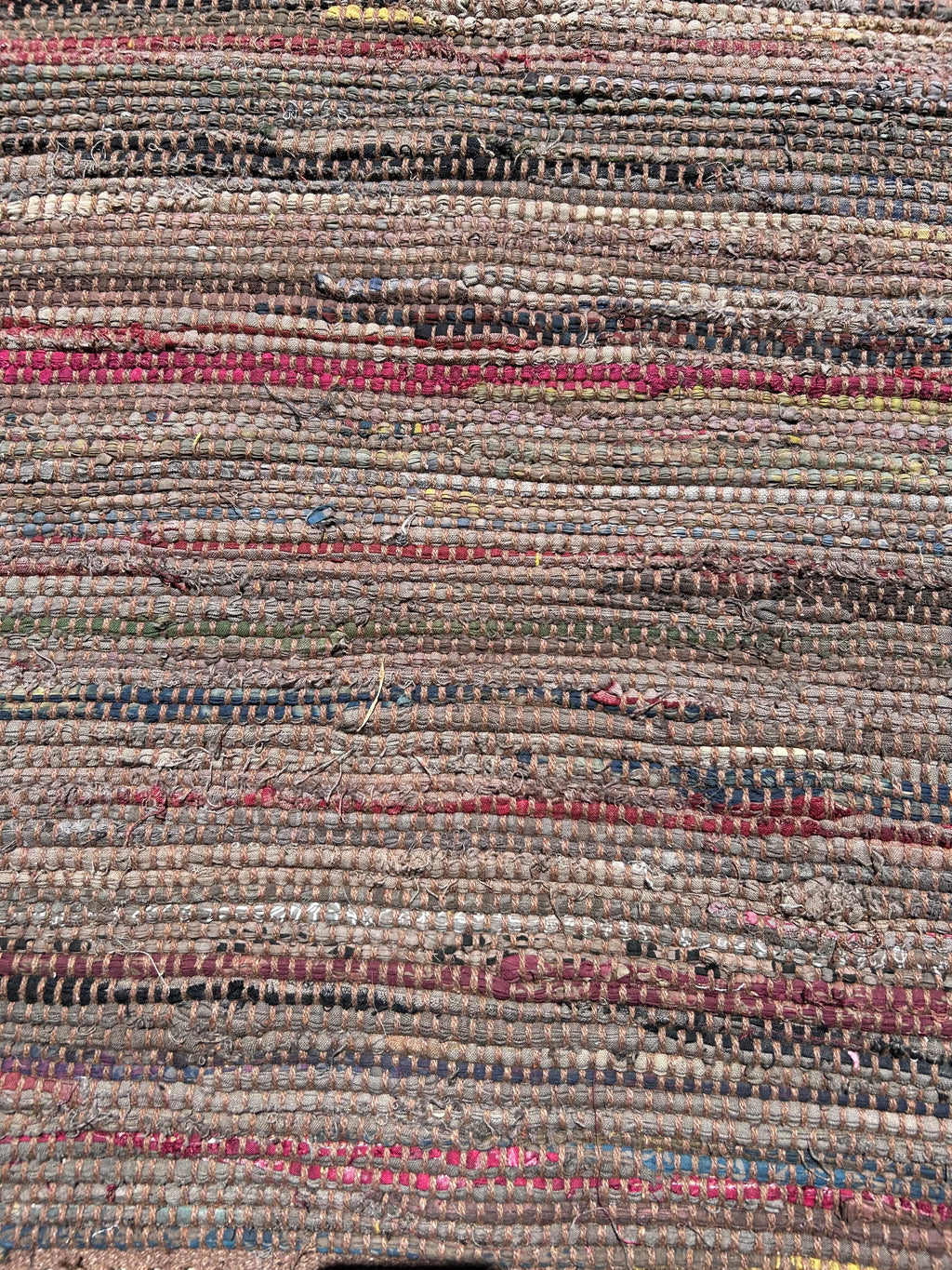 Close-up of a textured rug with multicolored stripes