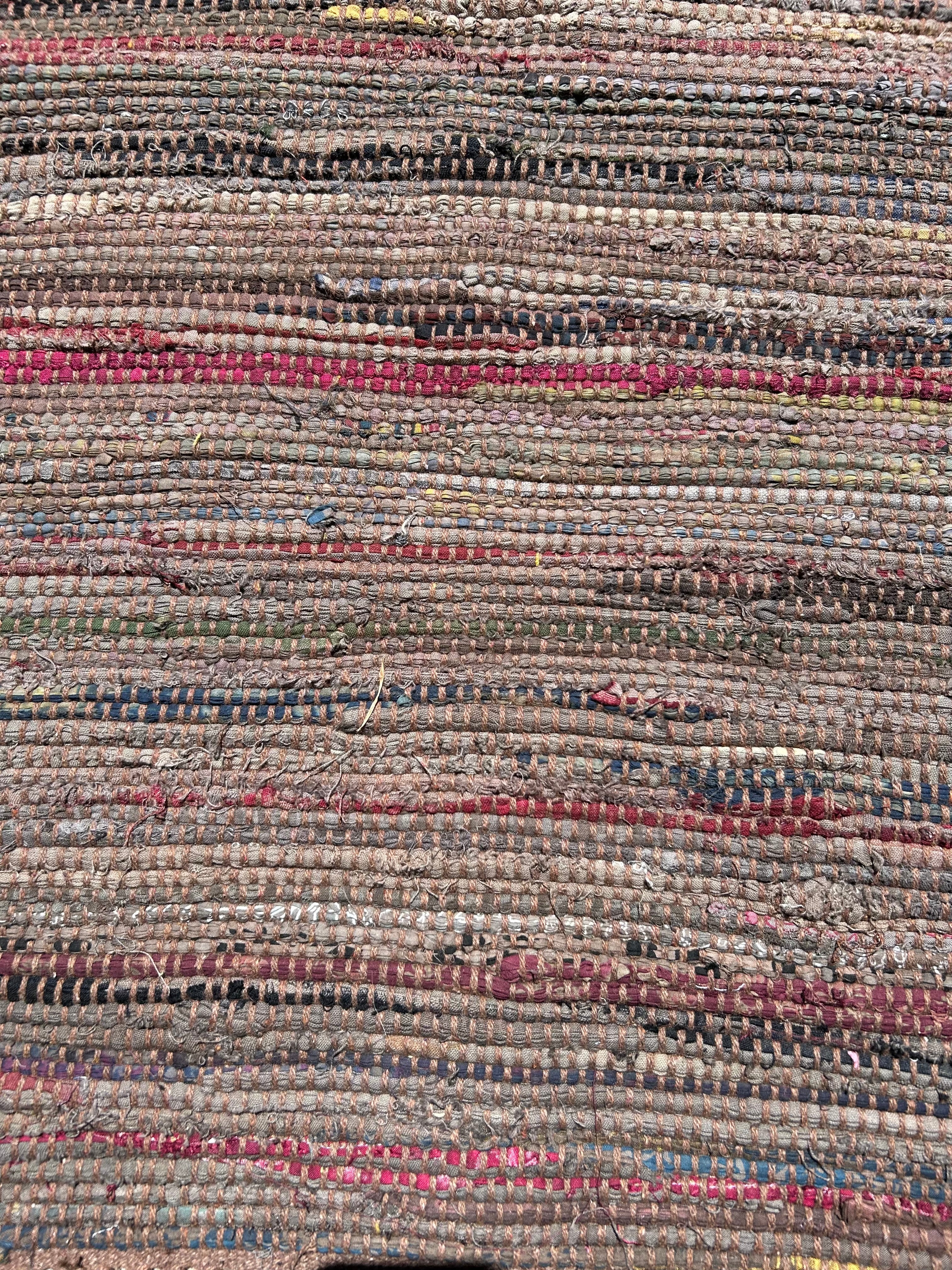 Close-up of a textured rug with multicolored stripes