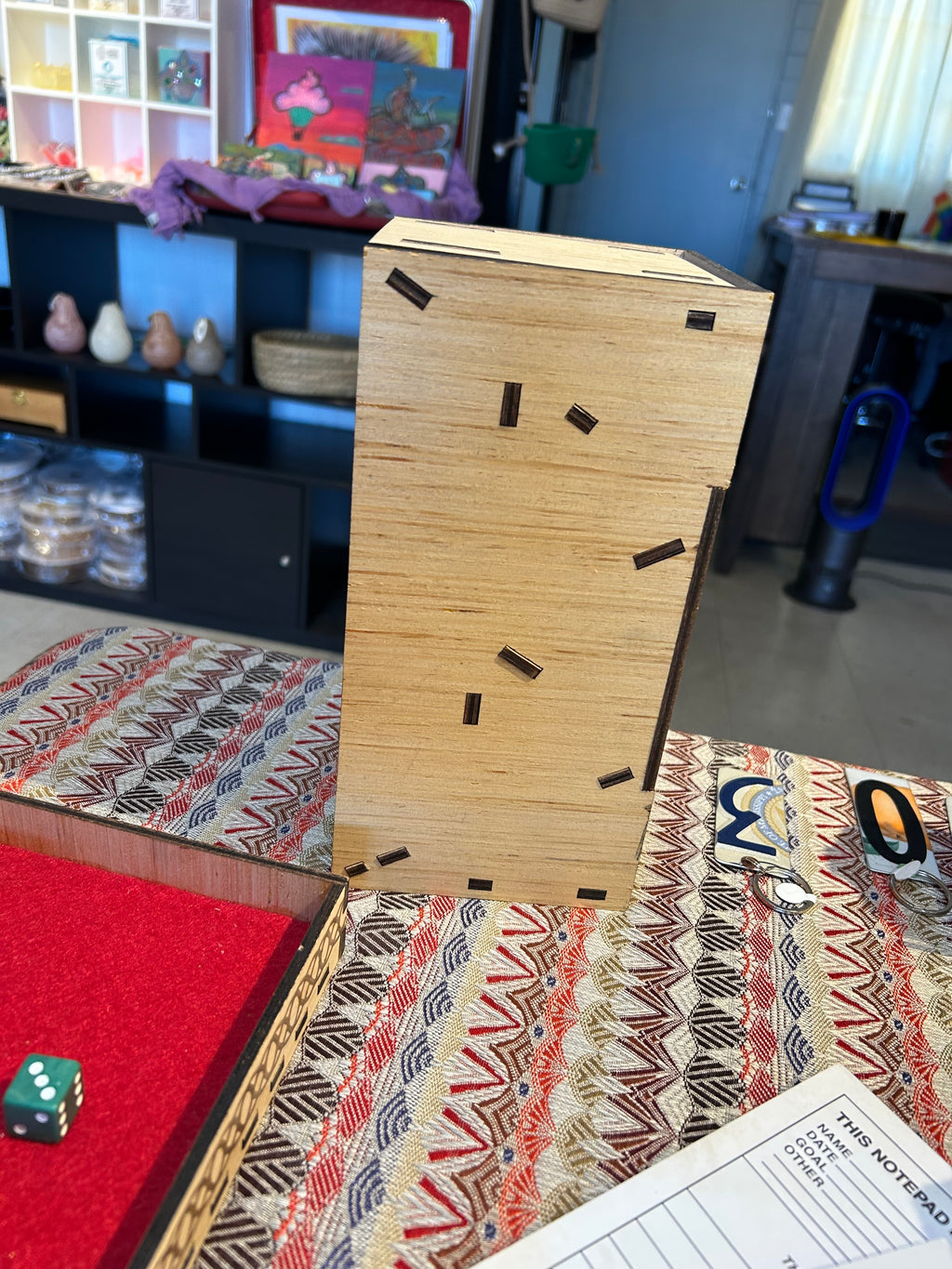 Wooden Dice Tower side view on a patterned surface