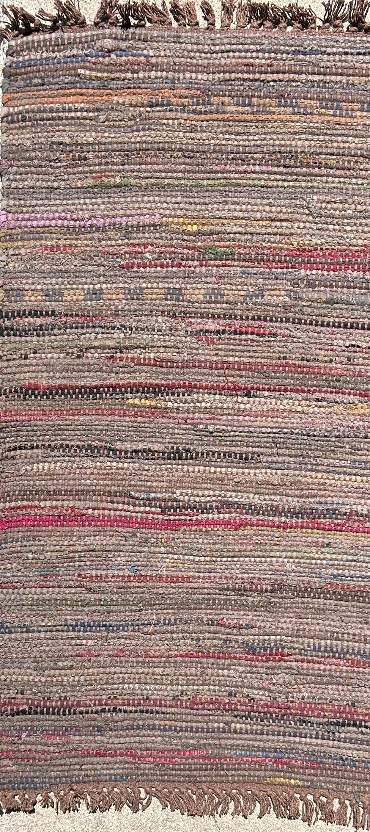 Close up of woven rug with fringe