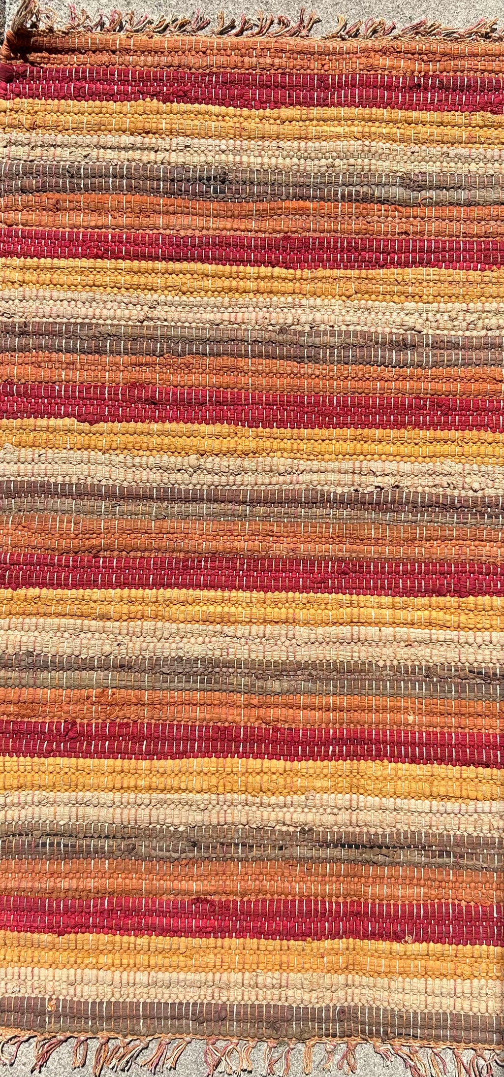 Close-up of a multicolored woven fabric with horizontal stripes.
