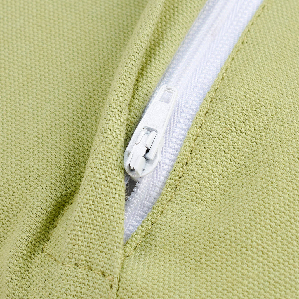 Close-up of a green fabric with a white zipper