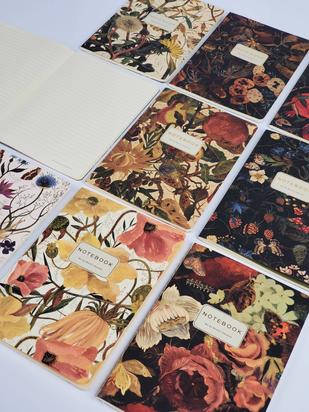 Set of floral notebooks with decorative covers on a white background