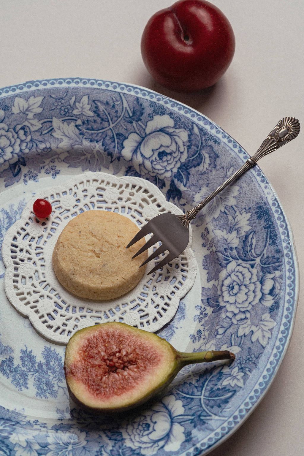 Fruit and cookie on a decorative plate with a fork