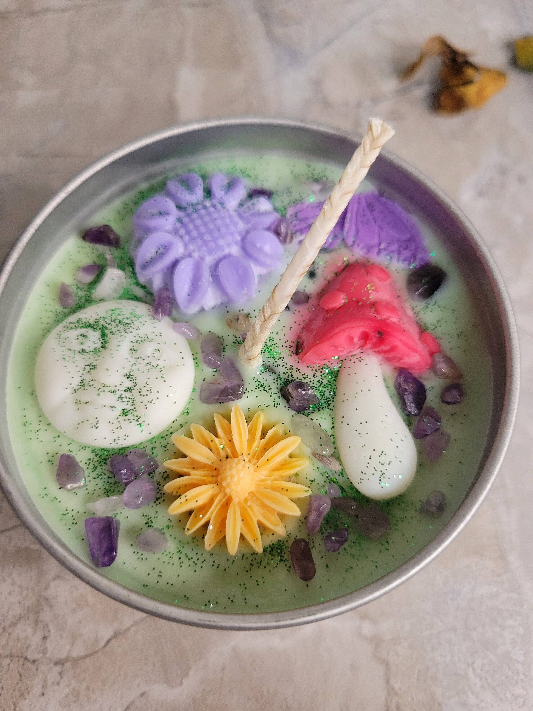 Soy Candle, colorful flower-shaped objects, and a straw on a light background