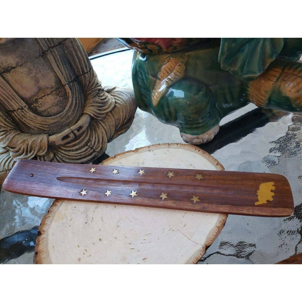 Wooden tool with star patterns on a stone surface