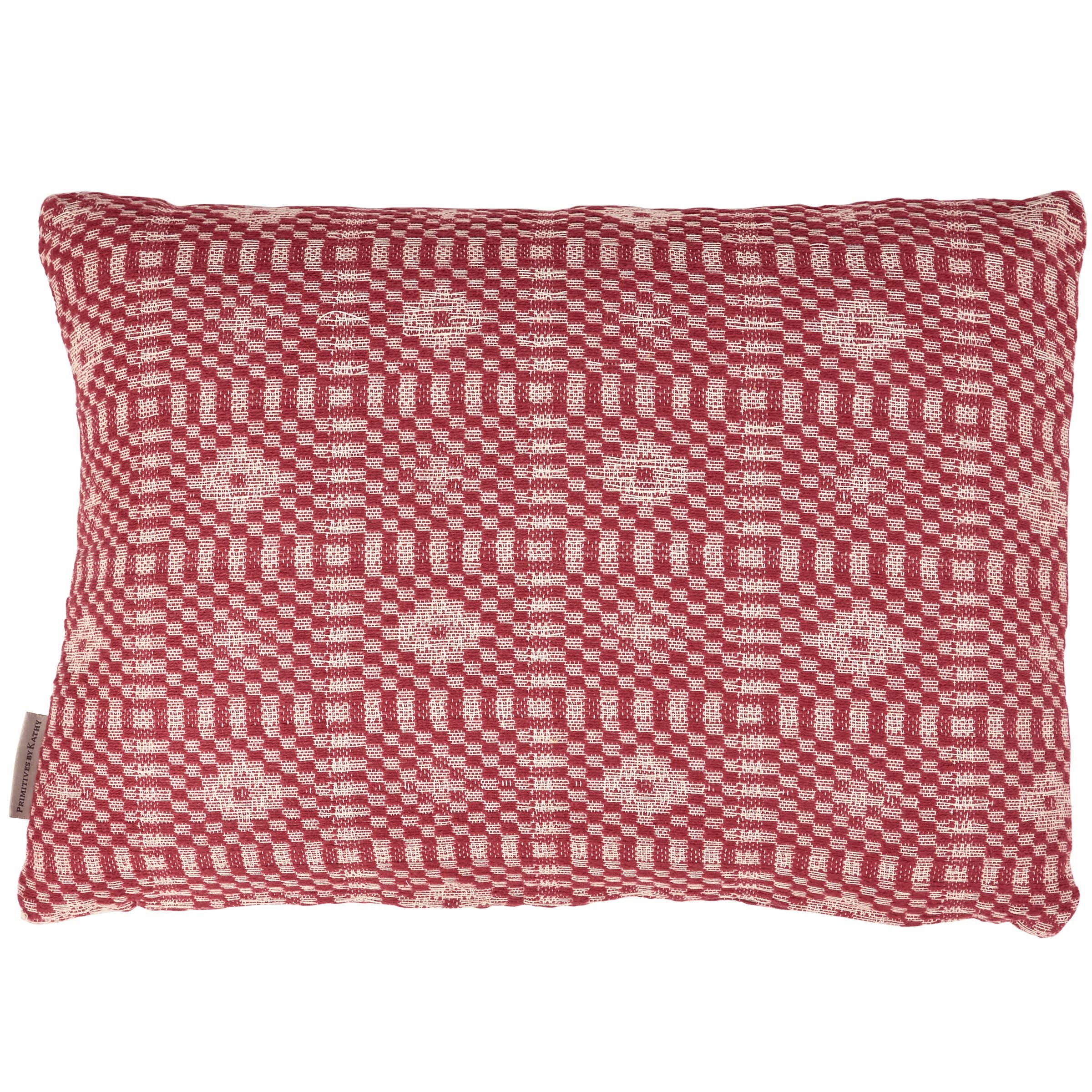 Red and white patterned pillow on a white background
