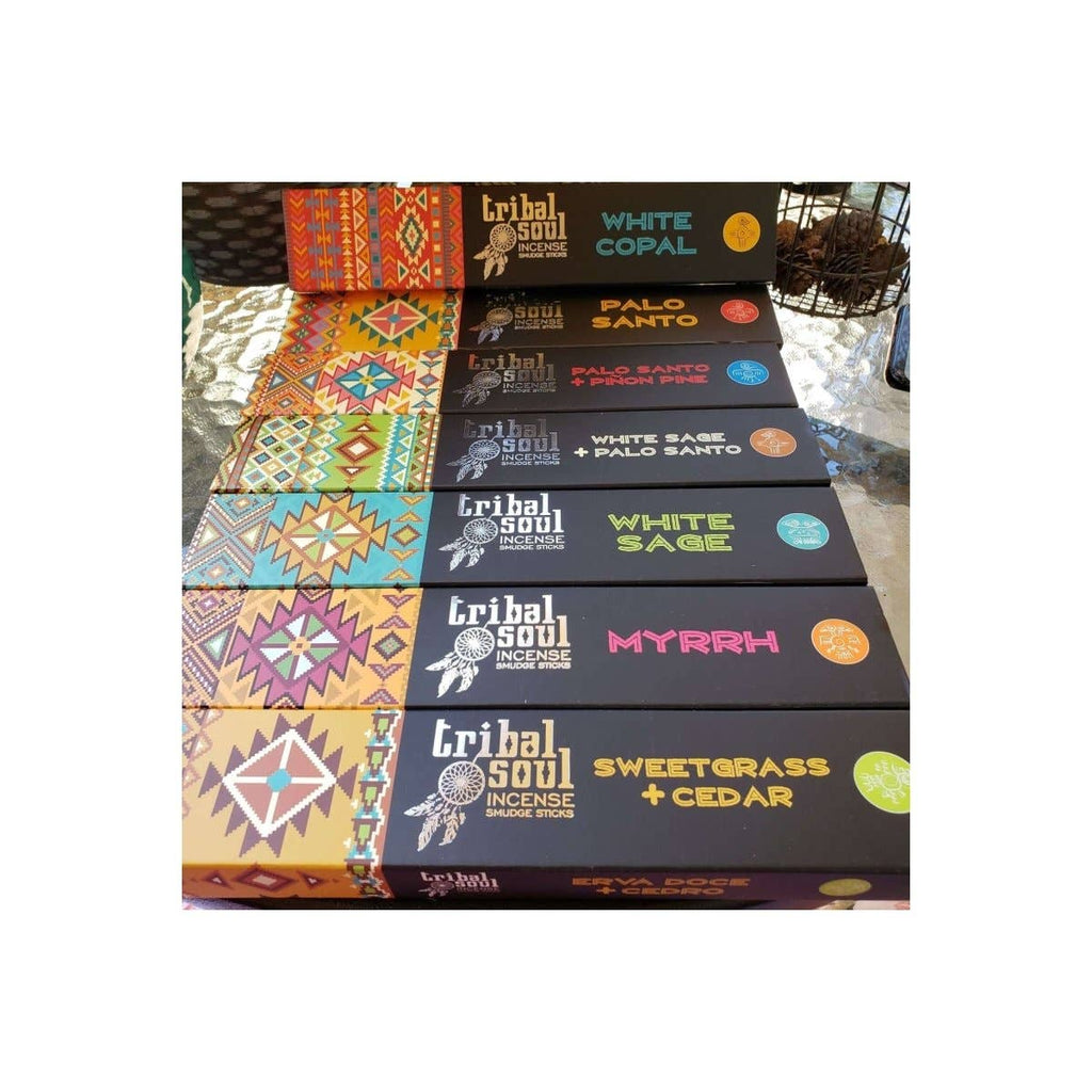 A box of Tribal Soul incense sticks with various colorful designs and fragrance names such as White Sage, Palo Santo, and Mryrh.