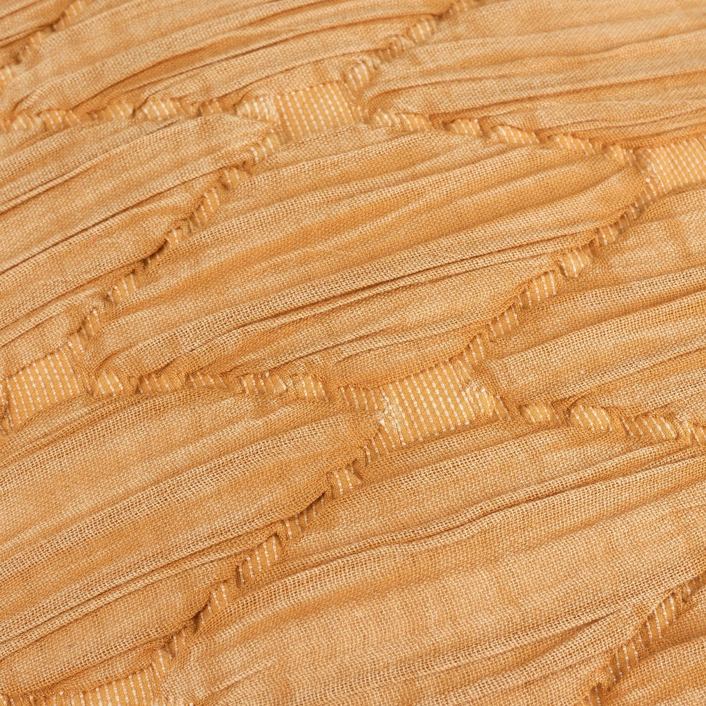 Close-up of beige pleated fabric texture