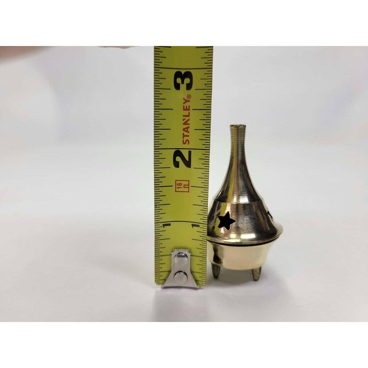 Small brass cone-shaped incense holder next to a measuring tape on a white background