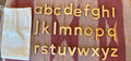Maple Wood Mineral Oil Sealed Lower Case Letters from Alphabet on pink background