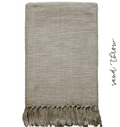 Tan colored handwoven cotton throw blanket with fringe on white background
